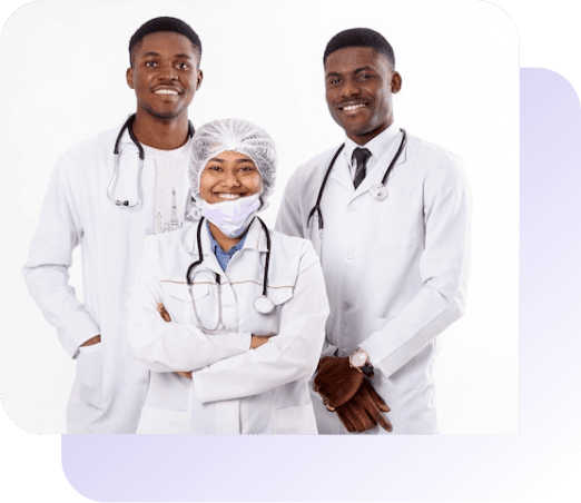 Three doctors with their arms folded and smiling with stethoscopes around their necks